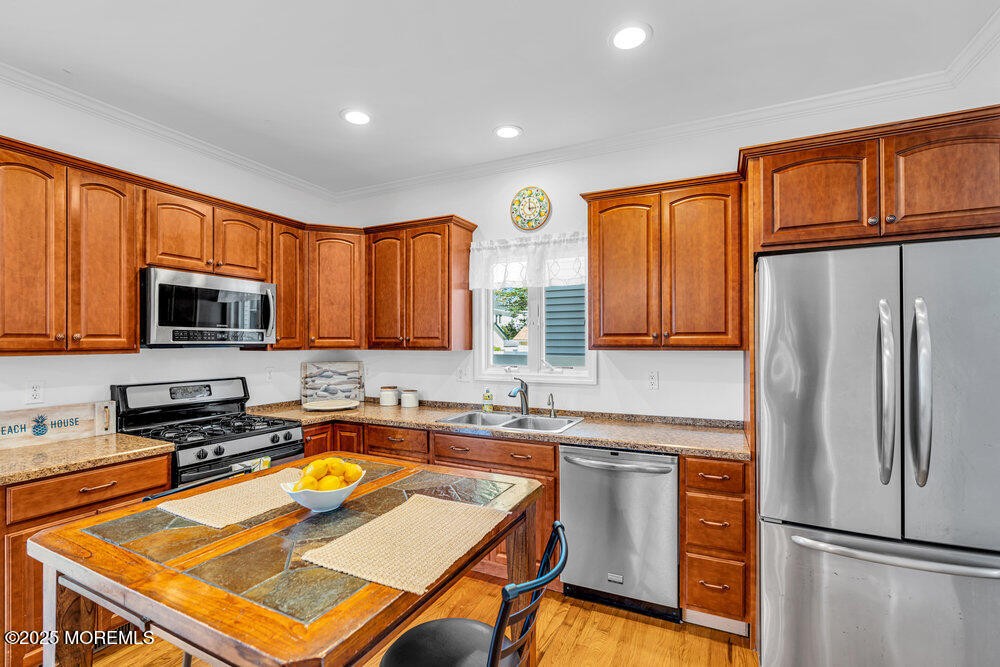 1825 Pine Terrace Lake Como, NJ 07719 - Photo 15 of 53 a kitchen with stainless steel appliances granite countertop a refrigerator a sink dishwasher a stove and white cabinets with wooden floor