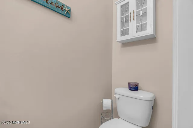 a white toilet sitting next to a bathroom sink