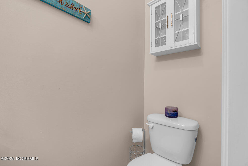 1825 Pine Terrace Lake Como, NJ 07719 - Photo 21 of 53 a white toilet sitting next to a bathroom sink