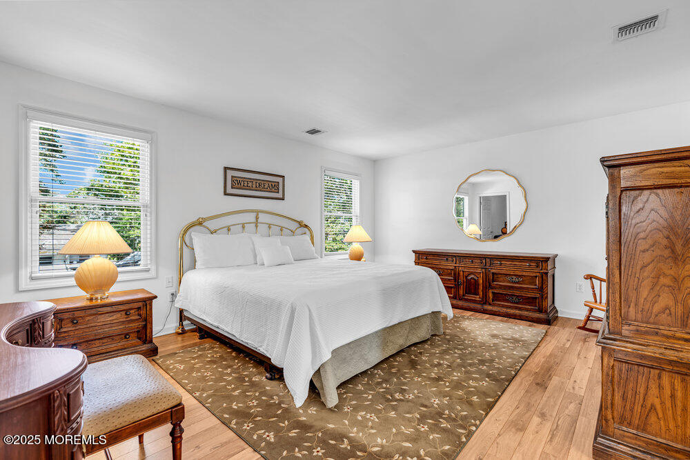 1825 Pine Terrace Lake Como, NJ 07719 - Photo 26 of 53 a bedroom with a bed a mirror and a window