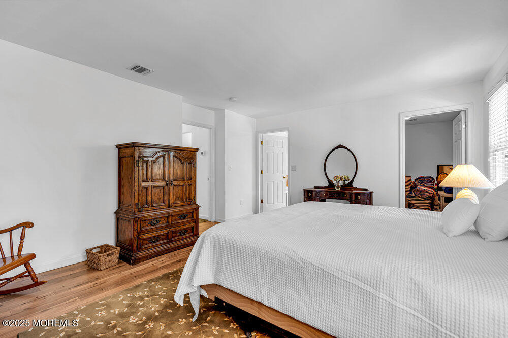 1825 Pine Terrace Lake Como, NJ 07719 - Photo 28 of 53 a bedroom with a bed and wooden floor