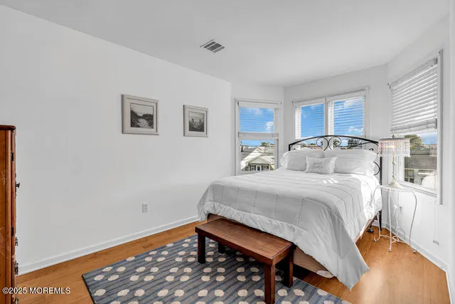 a bedroom with two beds and a window