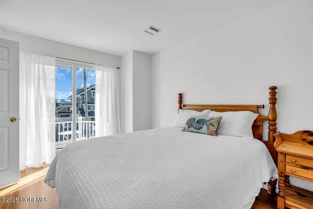 a view of a patio with table and chairs potted plants and large tree