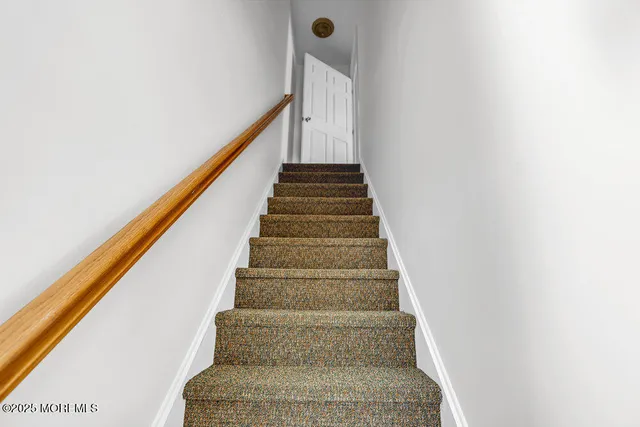 a view of a chair and table in the back yard of the house