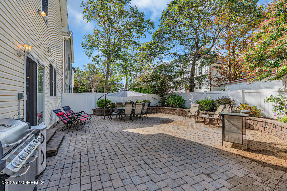 1825 Pine Terrace Lake Como, NJ 07719 - Photo 41 of 53 a view of a patio with table and chairs potted plants and large tree