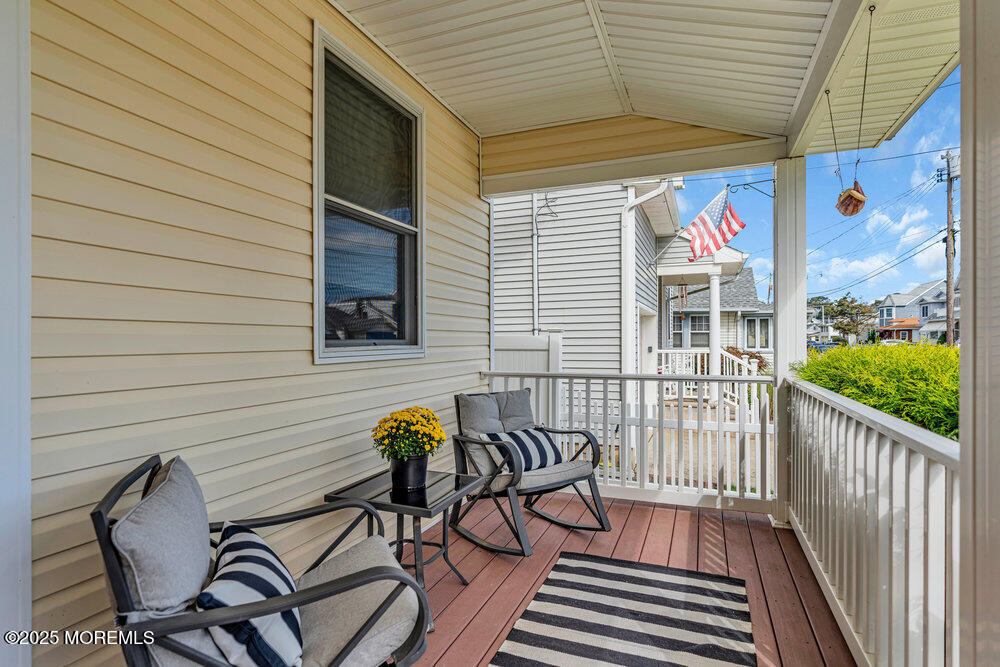 1825 Pine Terrace Lake Como, NJ 07719 - Photo 5 of 53 a view of a patio with table and chairs and wooden floor