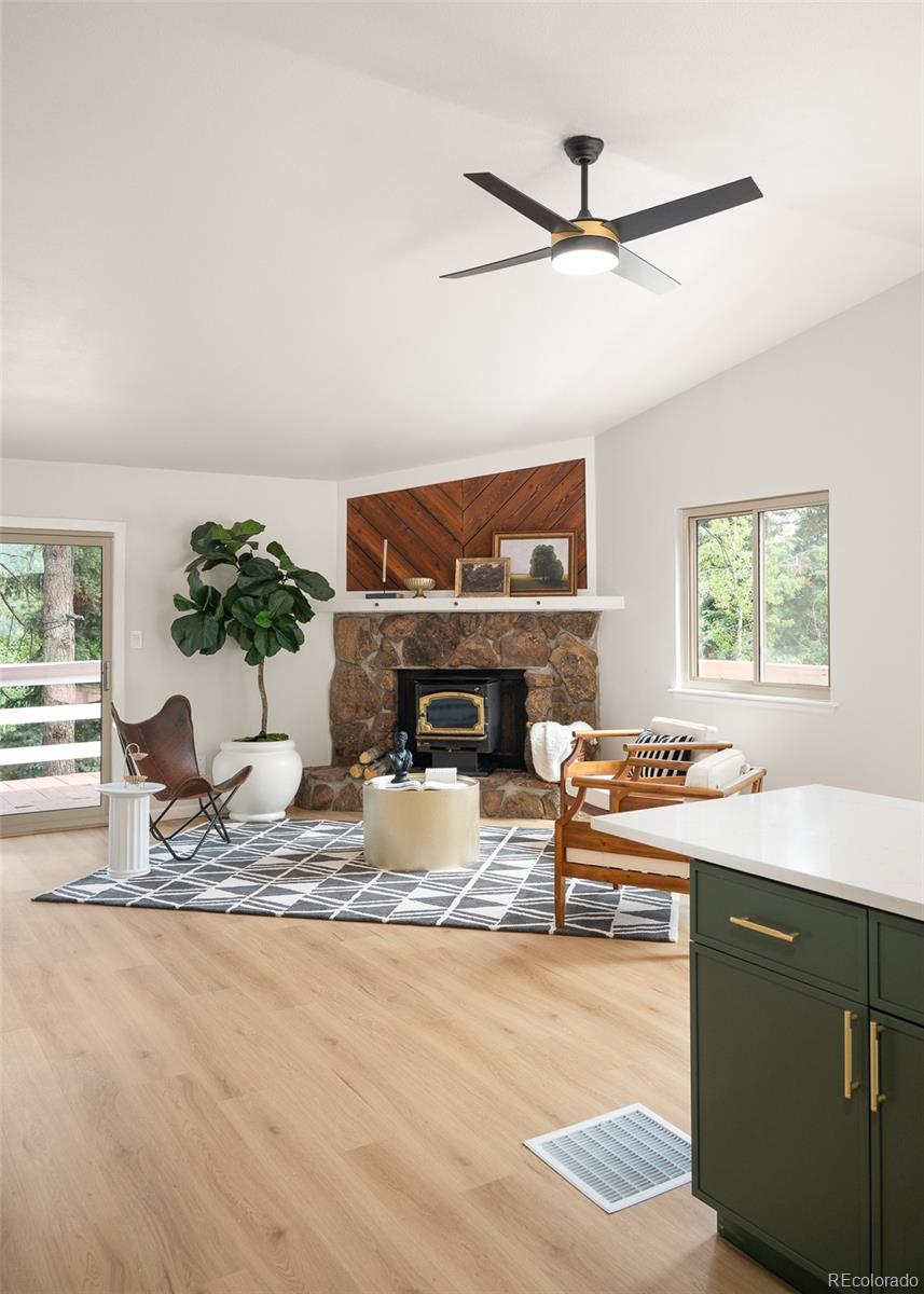 19424 Silver Ranch Road Conifer, CO 80433 - Photo 11 of 34 a living room with furniture a window and a fireplace