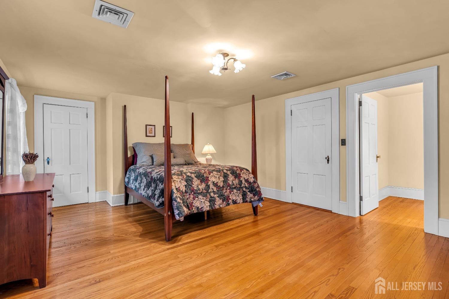 3 Edgemere Drive Matawan, NJ 07747 - Photo 19 of 43 a spacious bedroom with a bed and wooden floor
