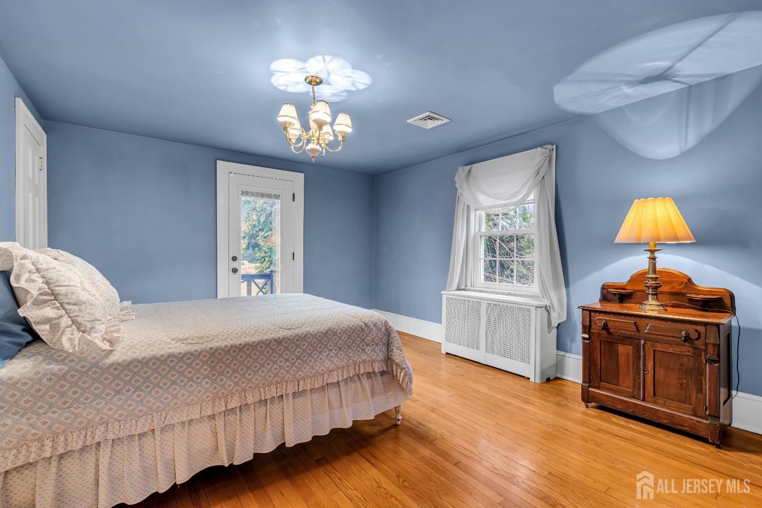 3 Edgemere Drive Matawan, NJ 07747 - Photo 25 of 43 a bedroom with a bed and a chandelier