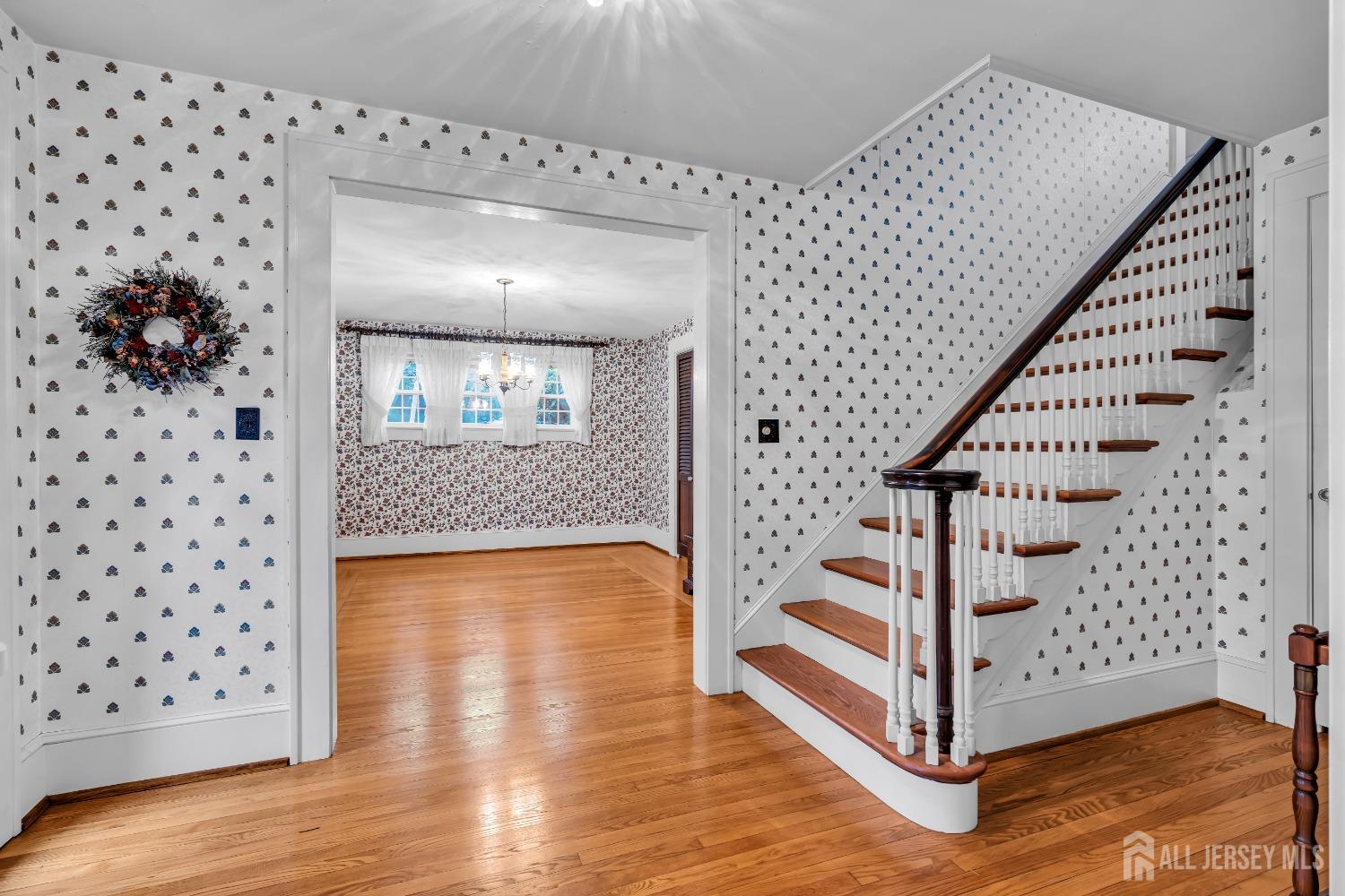 3 Edgemere Drive Matawan, NJ 07747 - Photo 4 of 43 a view of a hallway with wooden floor and staircase
