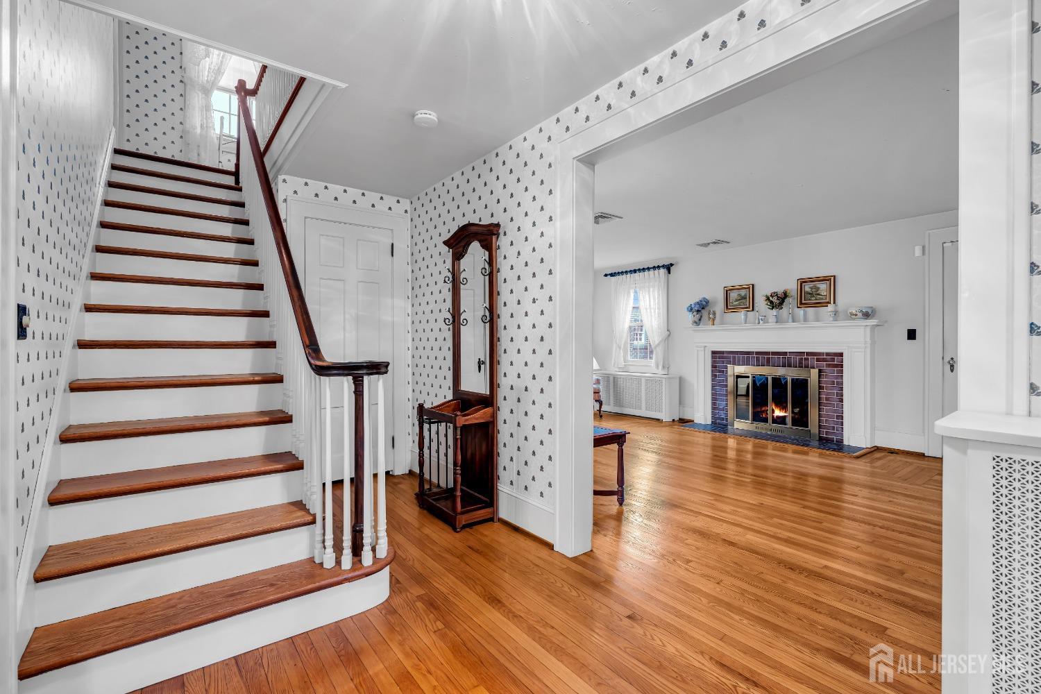3 Edgemere Drive Matawan, NJ 07747 - Photo 5 of 43 a view of a livingroom with wooden floor and a fireplace