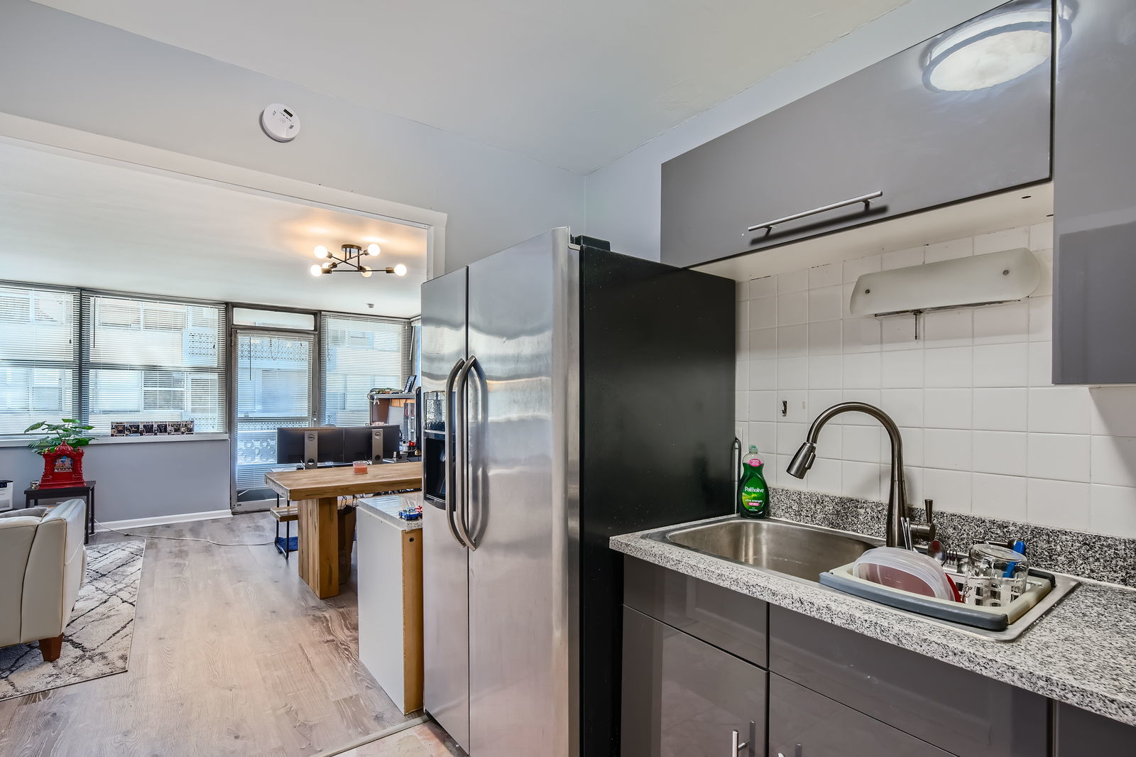 6301 North Sheridan Road, Unit 10F Chicago, IL 60660 - Photo 11 of 19 a kitchen with refrigerator and furniture