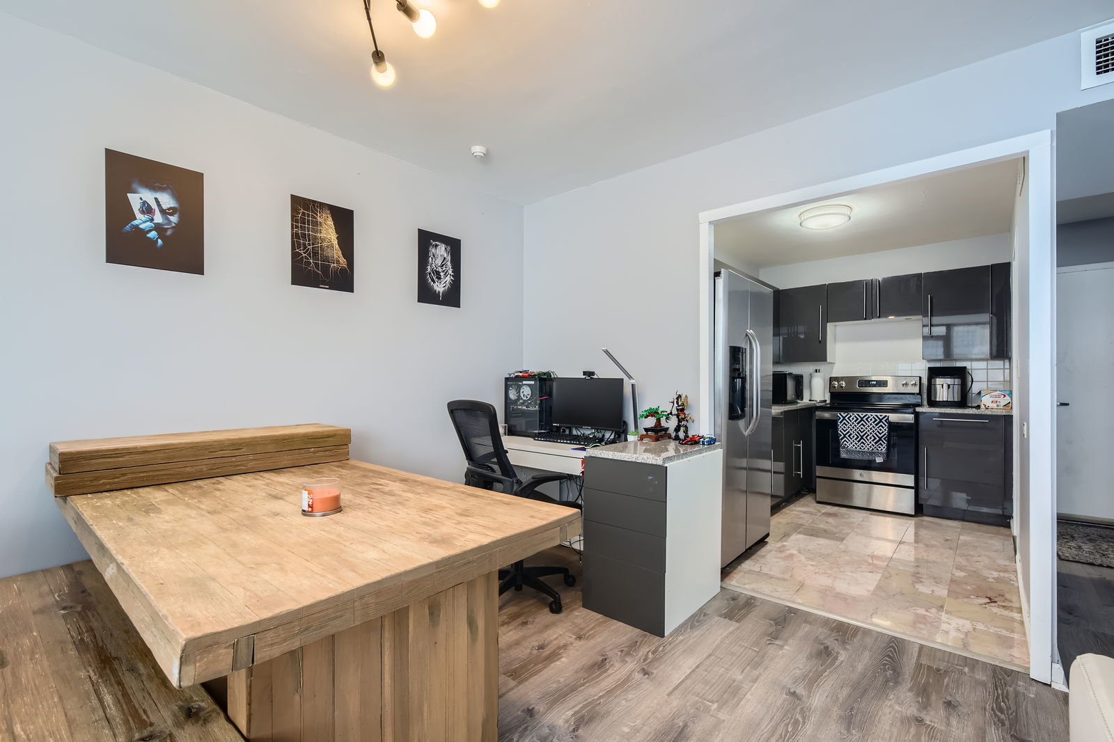 6301 North Sheridan Road, Unit 10F Chicago, IL 60660 - Photo 9 of 19 a kitchen with a stove a refrigerator and a dining table