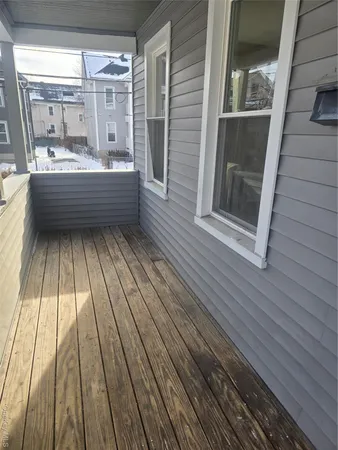 a room with wooden floor and windows