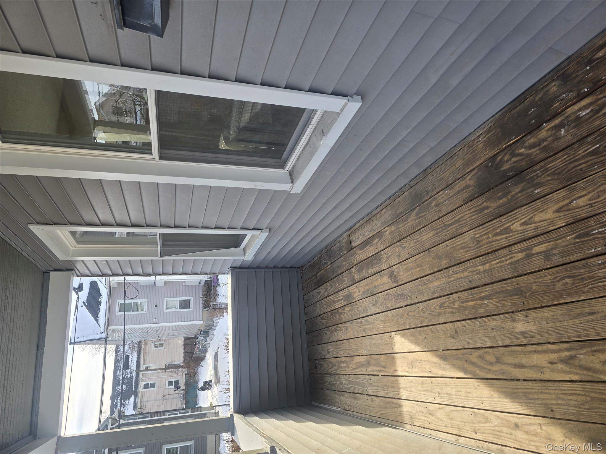 30 South White Street Poughkeepsie, NY 12601 - Photo 2 of 10 a room with wooden floor and windows