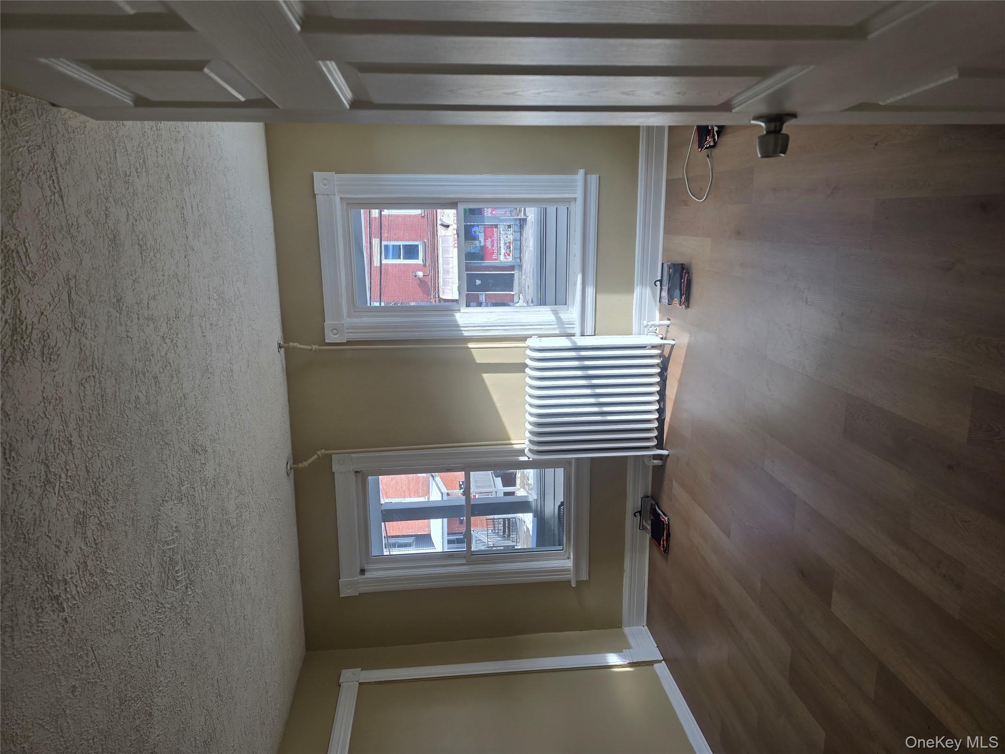 30 South White Street Poughkeepsie, NY 12601 - Photo 3 of 10 an empty room with wooden floor and windows