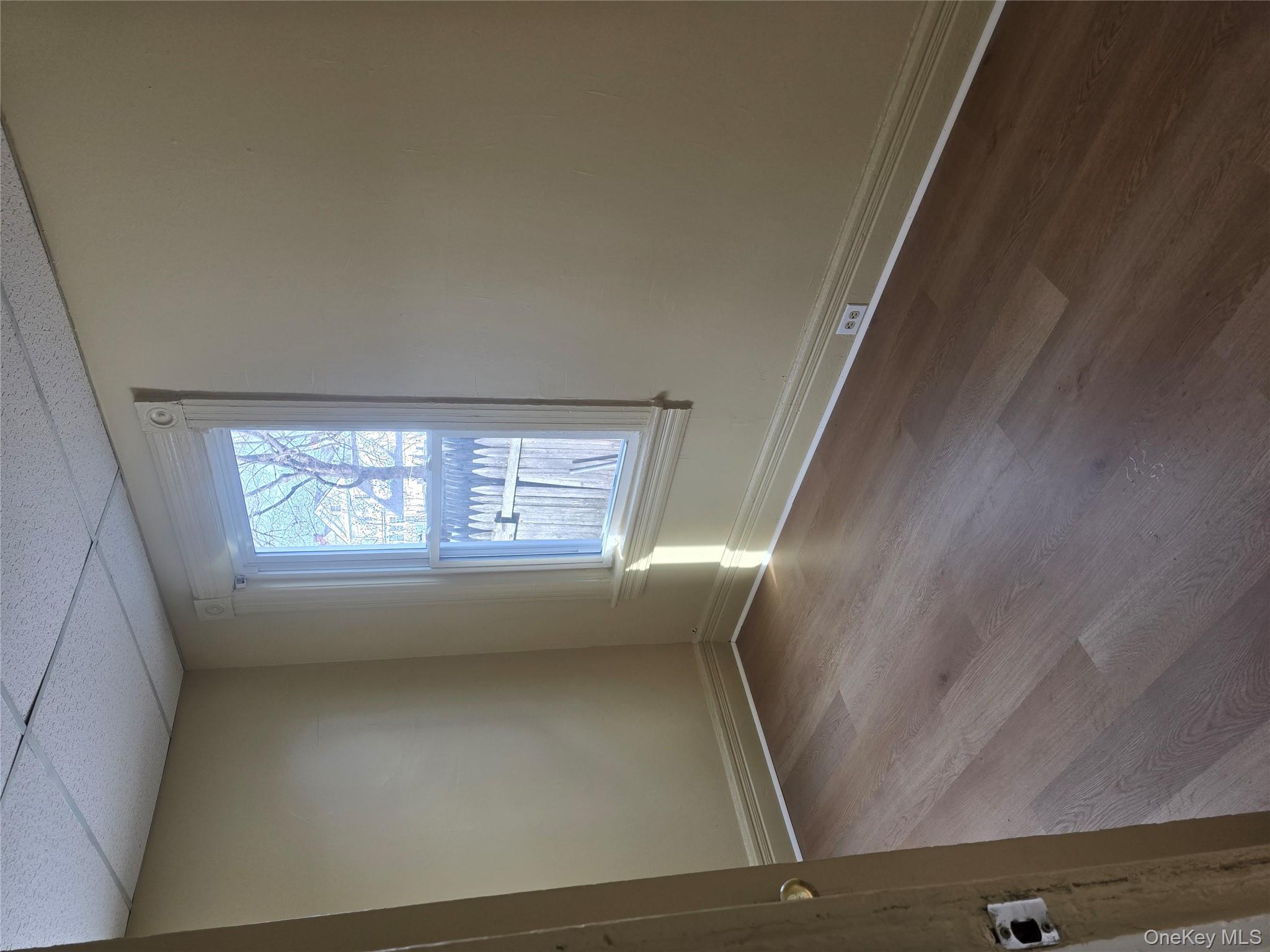 30 South White Street Poughkeepsie, NY 12601 - Photo 4 of 10 an empty room with wooden floor and windows