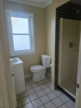 a bathroom with a toilet a sink and a mirror