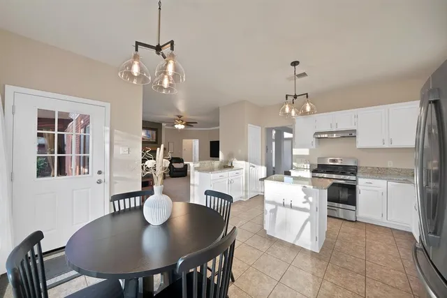 a large kitchen with a table and chairs