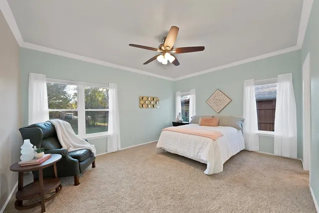 a bedroom with a bed and glass window