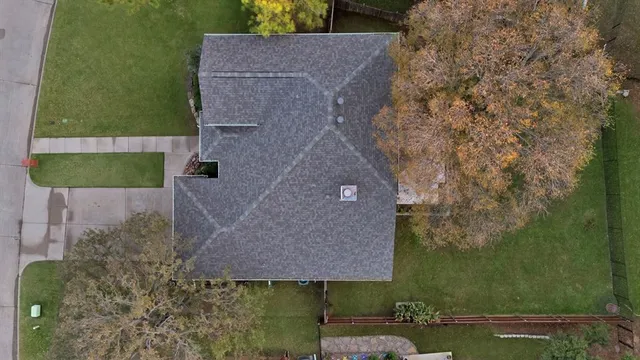 an aerial view of a house with a yard