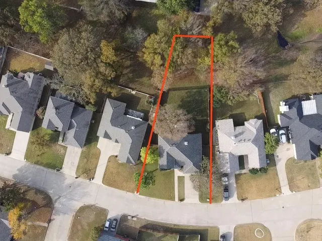 an aerial view of houses with outdoor space