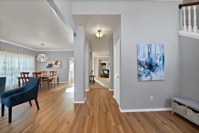 a view of a livingroom with furniture and hardwood floor