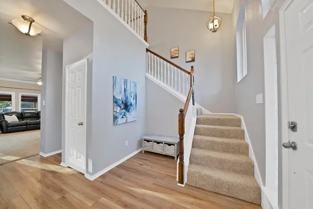 a view of entryway and hall with wooden floor