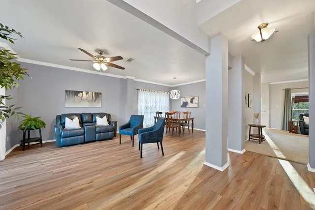 a living room with furniture and wooden floor