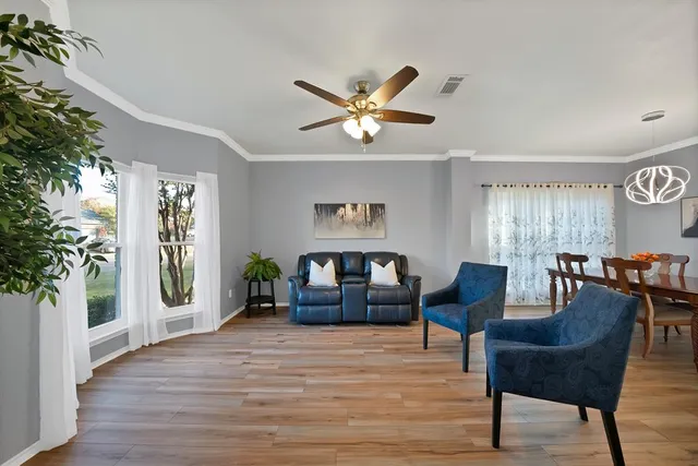 a view of a livingroom with furniture window and wooden floor