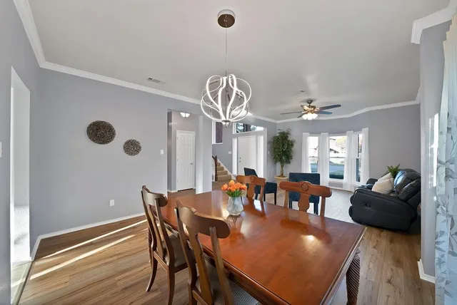 a view of a dining room with furniture and chandelier