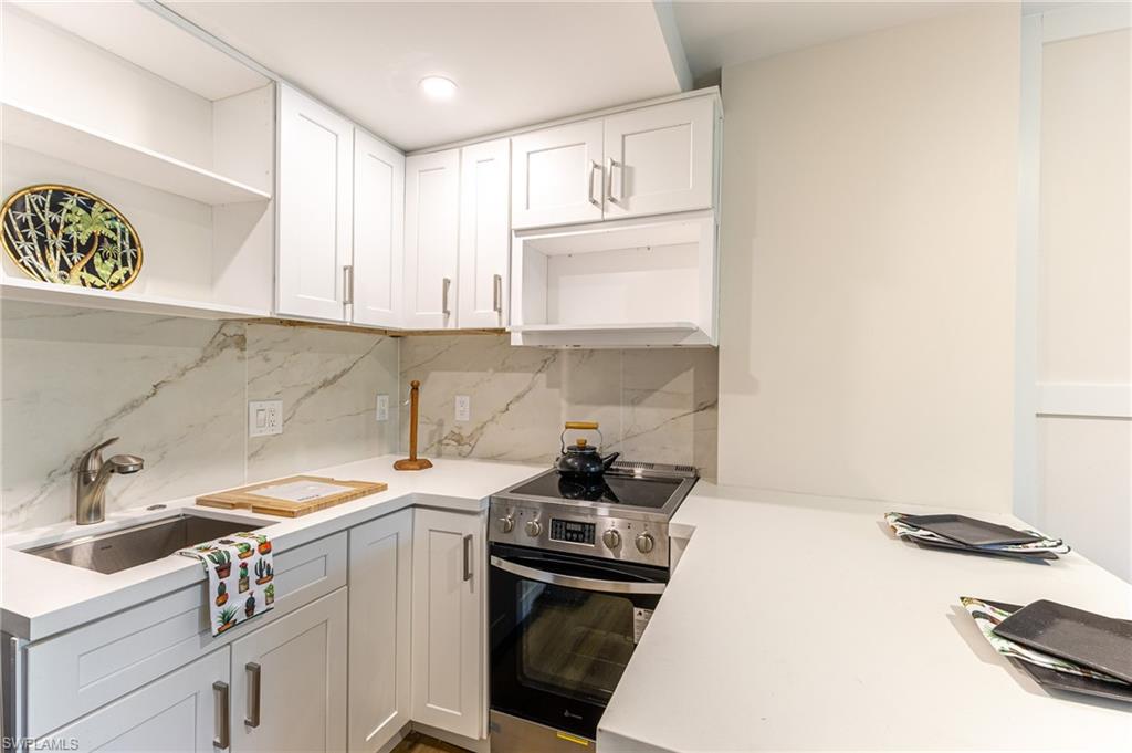 5 Bluebill Avenue, Unit 105 Naples, FL 34108 - Photo 15 of 26 a kitchen with a sink cabinets and appliances