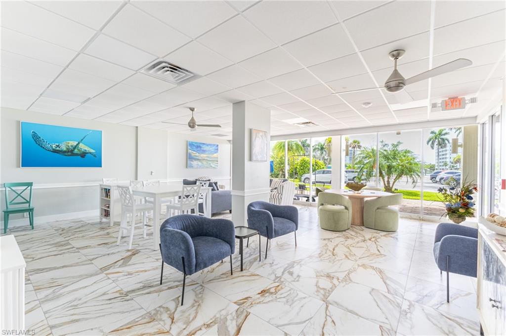 5 Bluebill Avenue, Unit 105 Naples, FL 34108 - Photo 23 of 26 a living room with furniture and a large window