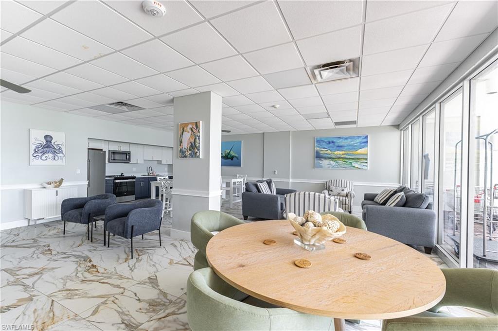 5 Bluebill Avenue, Unit 105 Naples, FL 34108 - Photo 24 of 26 a view of a dining room with furniture