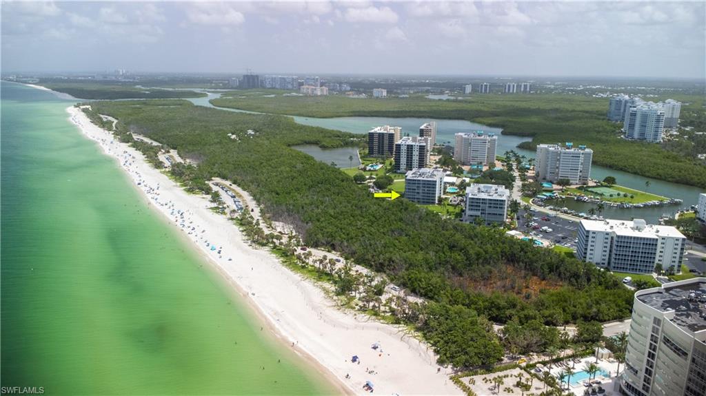 5 Bluebill Avenue, Unit 105 Naples, FL 34108 - Photo 8 of 26 a view of a lake with a yard