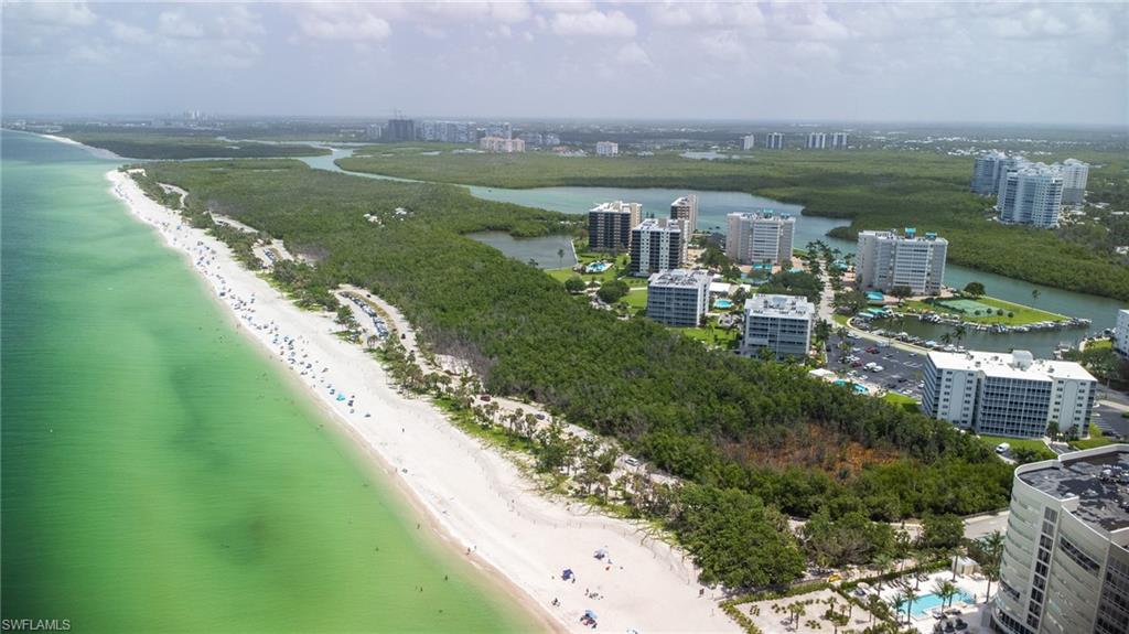 5 Bluebill Avenue, Unit 105 Naples, FL 34108 - Photo 9 of 26 a view of a lake with a yard