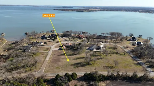 an aerial view of a house with a lake view