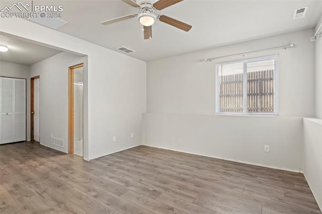 4763 Brant Road Colorado Springs, CO 80911 - Photo 22 of 26 Empty room with light hardwood / wood-style floors and ceiling fan