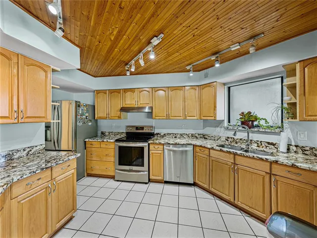 a bathroom with a granite countertop sink a toilet and mirror