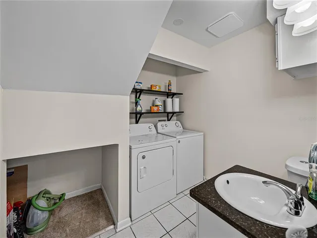 a bathroom with a granite countertop sink toilet and mirror