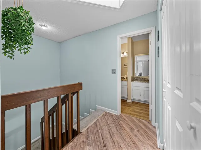 a view of a workspace with furniture and wooden floor