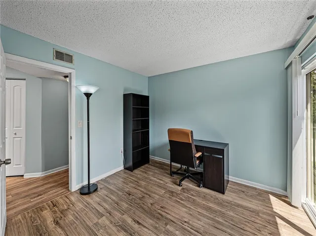 a spacious bathroom with a granite countertop sink and a mirror