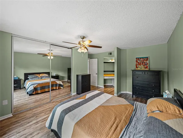 a bedroom with a bed and a large window