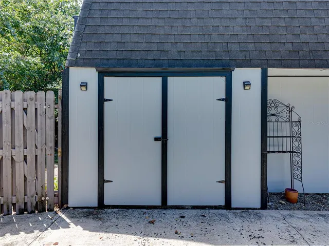 a view of a yard with plants and outdoor seating