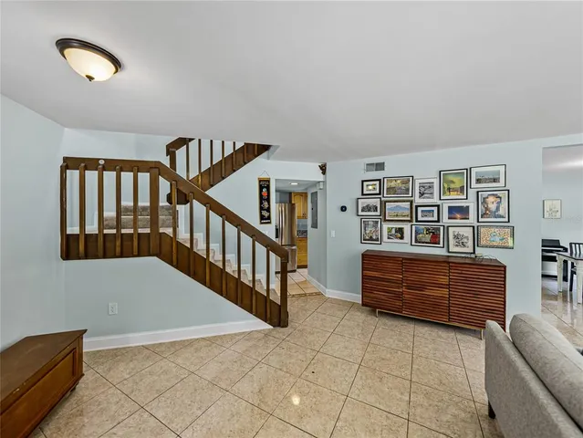 a living room with furniture and a book shelf