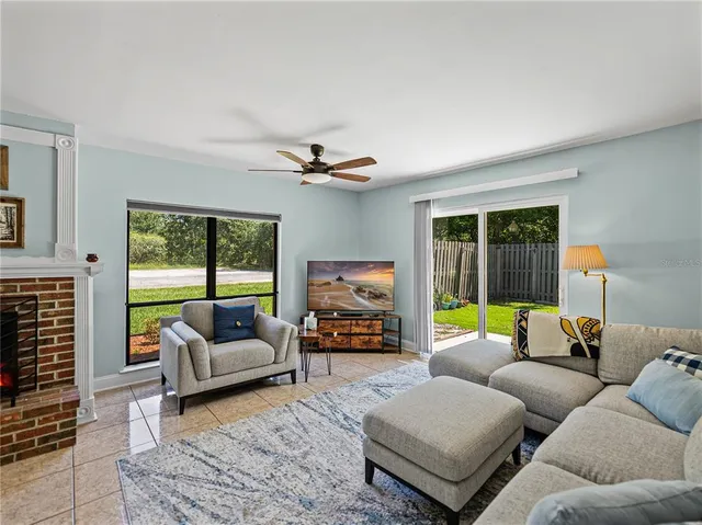 a living room with furniture and a floor to ceiling window