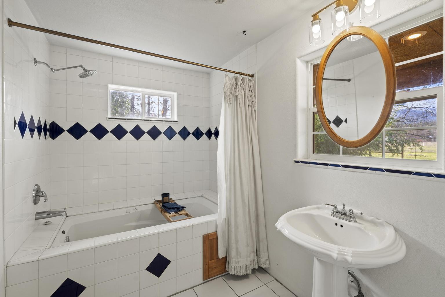 1190 Cedar Flat Road Williams, OR 97544 - Photo 20 of 45 a bathroom with a sink and a mirror