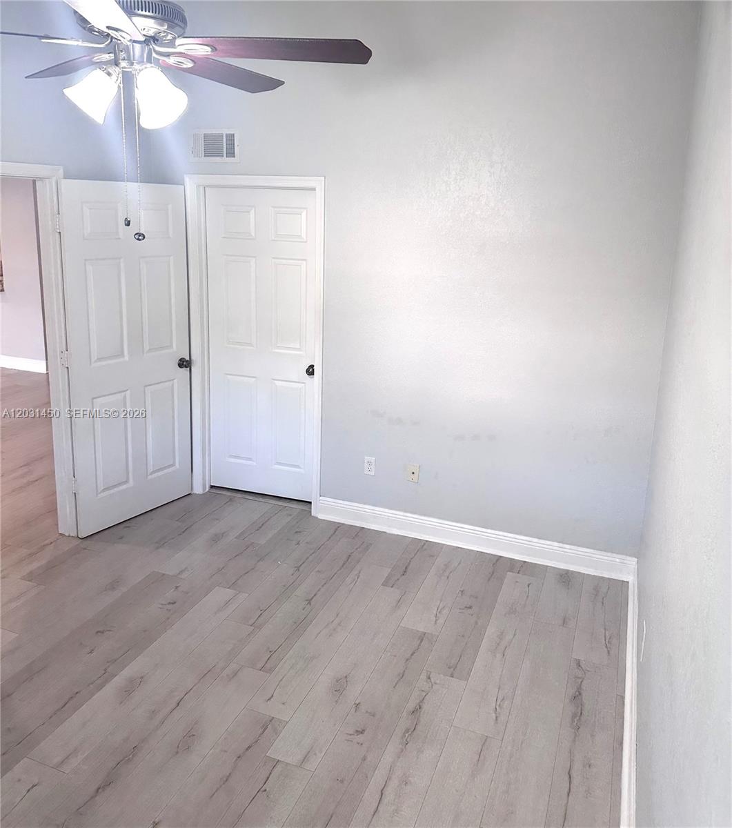 23398 Lyons Road, Unit 309 Boca Raton, FL 33428 - Photo 7 of 16 wooden floor in an empty room