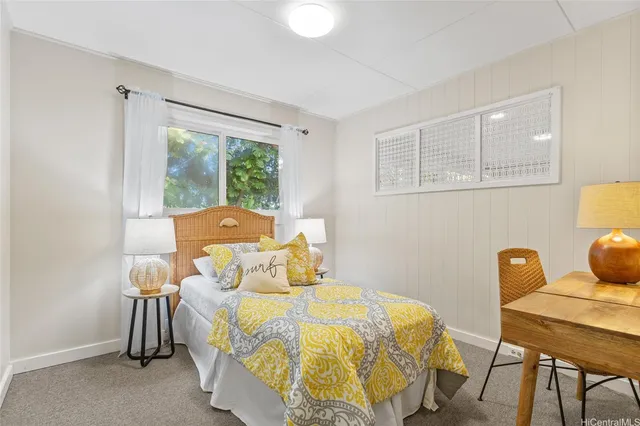 a bed sitting in a bedroom next to a window