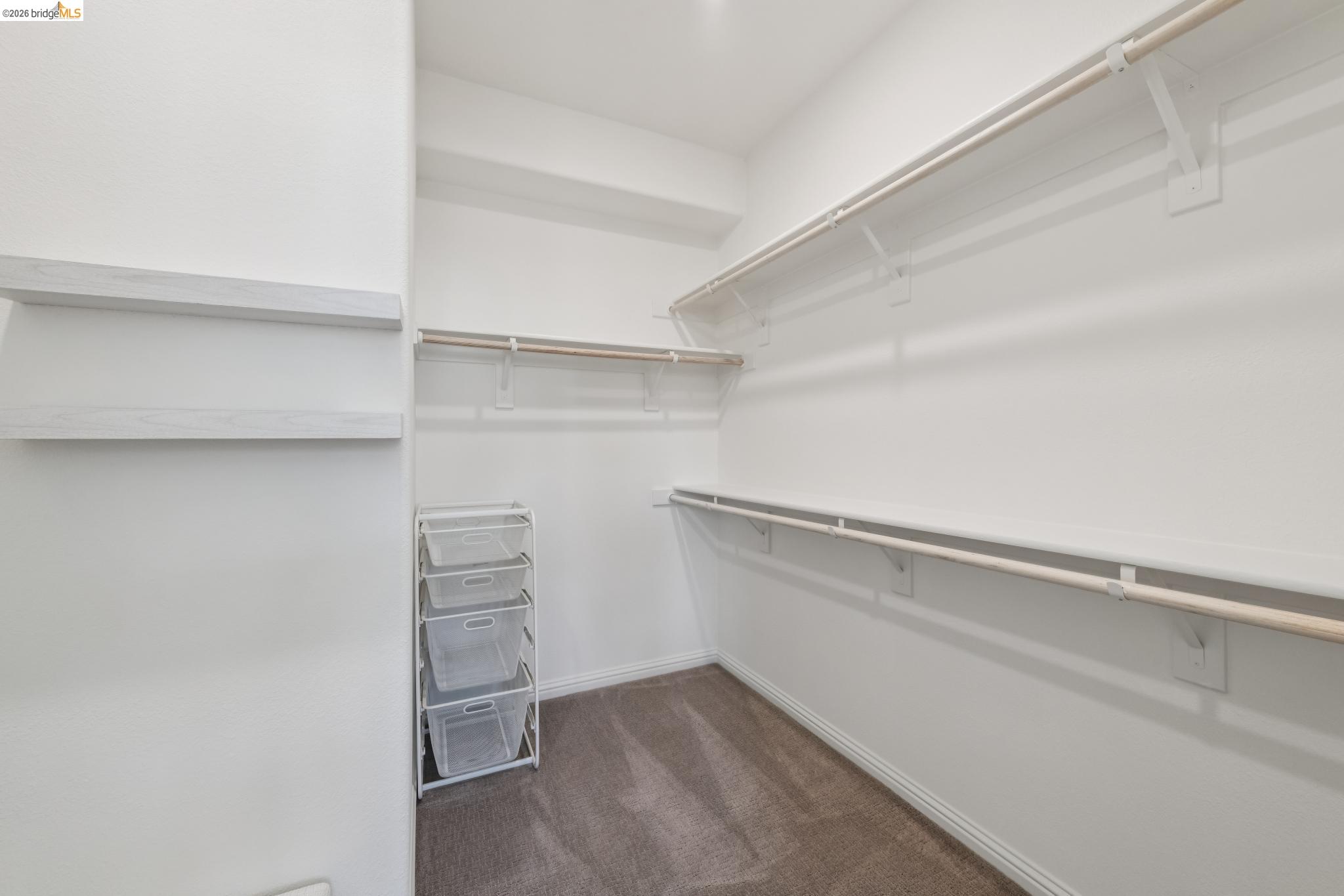 24157 Amaranth Loop Hayward, CA 94541 - Photo 40 of 63 Spacious walk-in closet featuring white walls, deep-pile carpet flooring, multiple shelving units, and ample hanging rods